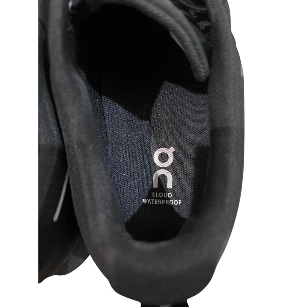 On Cloud waterproof running shoes for women in solid black. - Picture 8 of 9